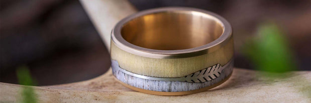 A close-up of a decorative ring on a wooden surface.