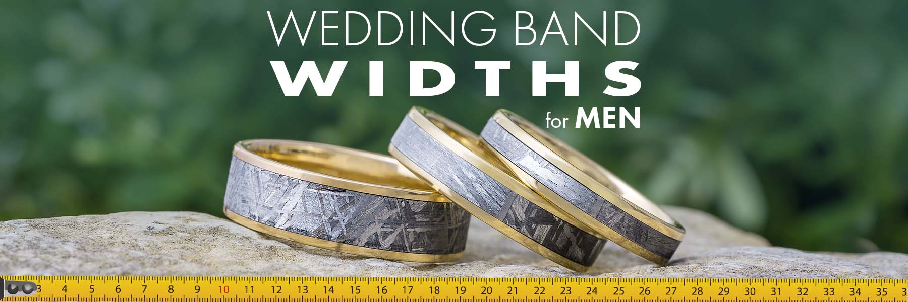 Three men's wedding bands of different widths on a measuring tape.