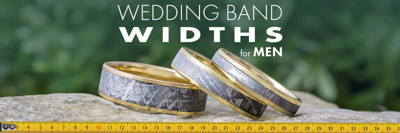 Three men's wedding bands of different widths on a measuring tape.