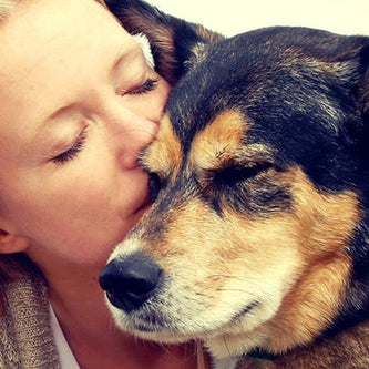 Lady kissing senior dog