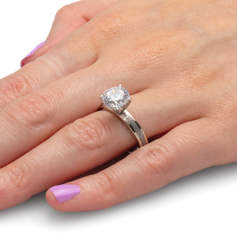 Hand showcasing a 3.0-carat diamond ring, highlighting the clear, sparkling stone and silver band.