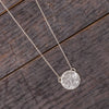 Meteorite necklace on wooden background