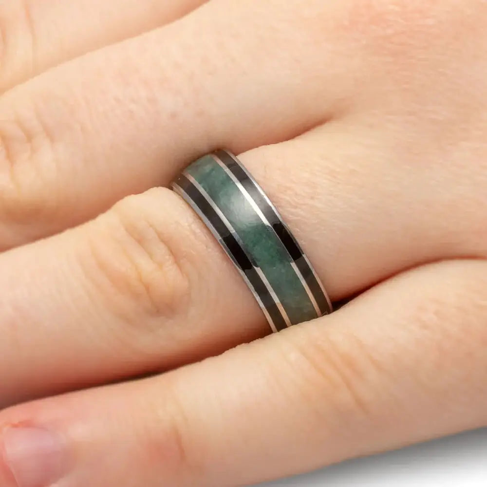 Jade and Blackwood wedding band on hand with gold accents