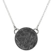 Close-up of meteorite round bezel necklace
