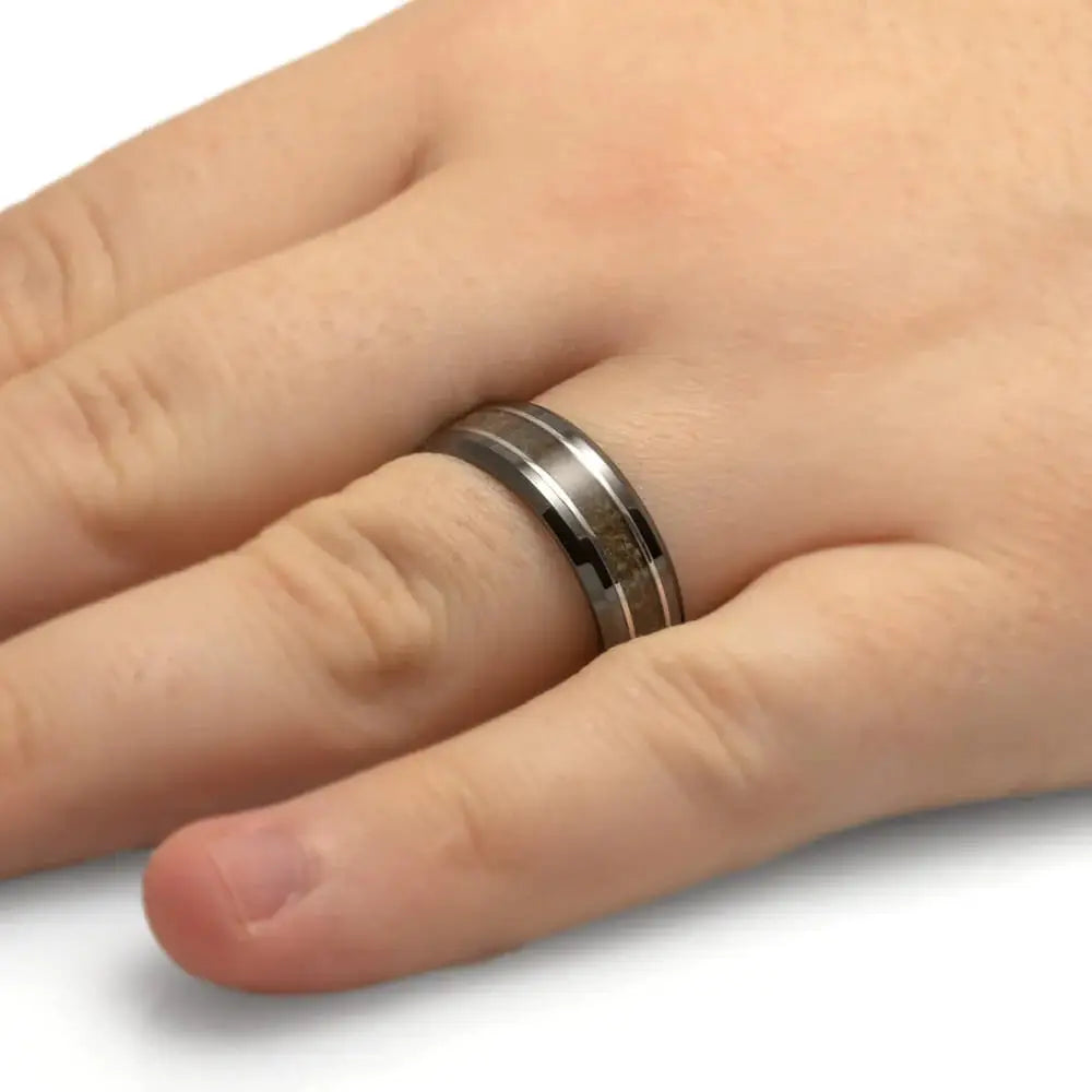 Dinosaur bone ring with titanium pinstripes on hand
