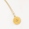 Yellow gold circle necklace with diamond starburst pendant
