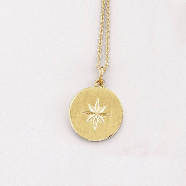 Yellow gold tiny circle necklace with starburst design