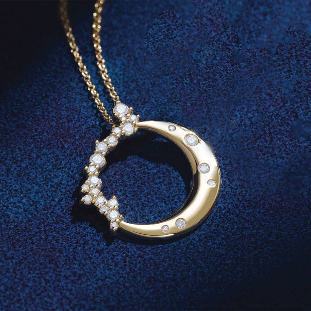 Diamond crescent moon necklace on blue background