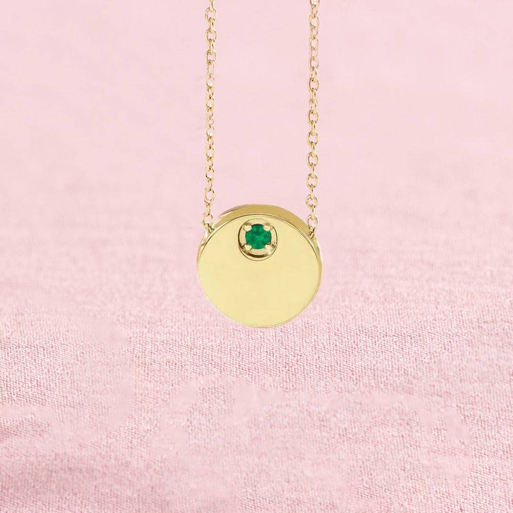 Emerald circle slide necklace on pink background