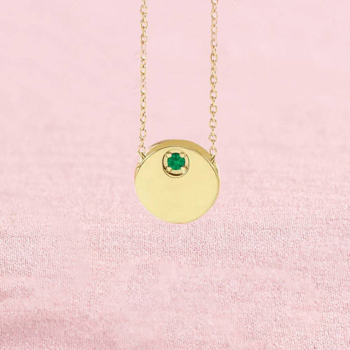 Emerald circle slide necklace on pink background