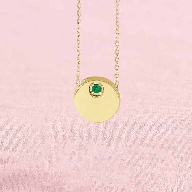 Emerald circle slide necklace on pink background
