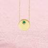 Emerald circle slide necklace on pink background