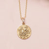 Yellow gold circle necklace with floral design on chain