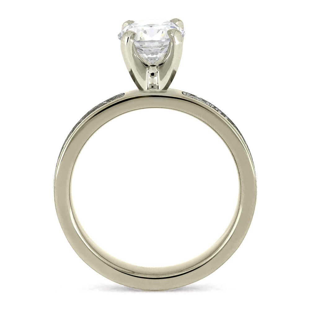 Classic 1.5-carat diamond engagement ring in a prong setting, featuring a simple silver band.