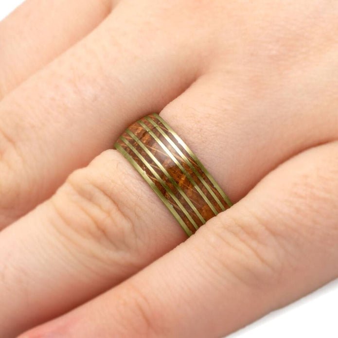 Rose gold whiskey barrel wedding band on finger