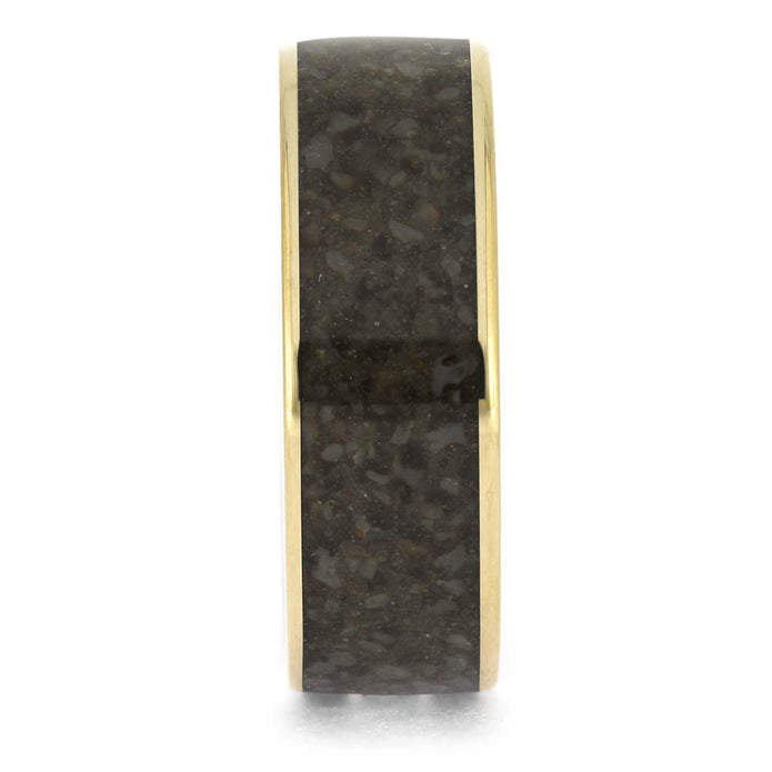 Gold ring with a black stone inlay on a white background