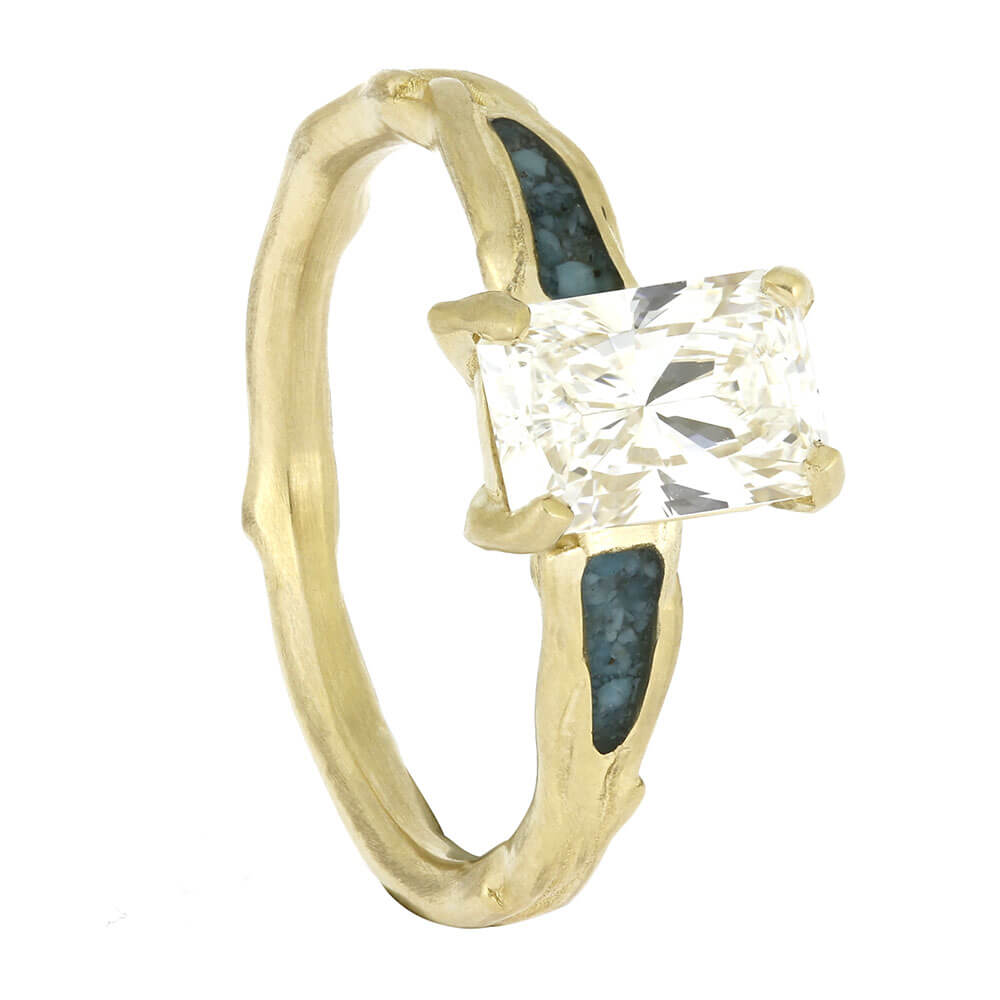 Gold ring with a large diamond on a white background