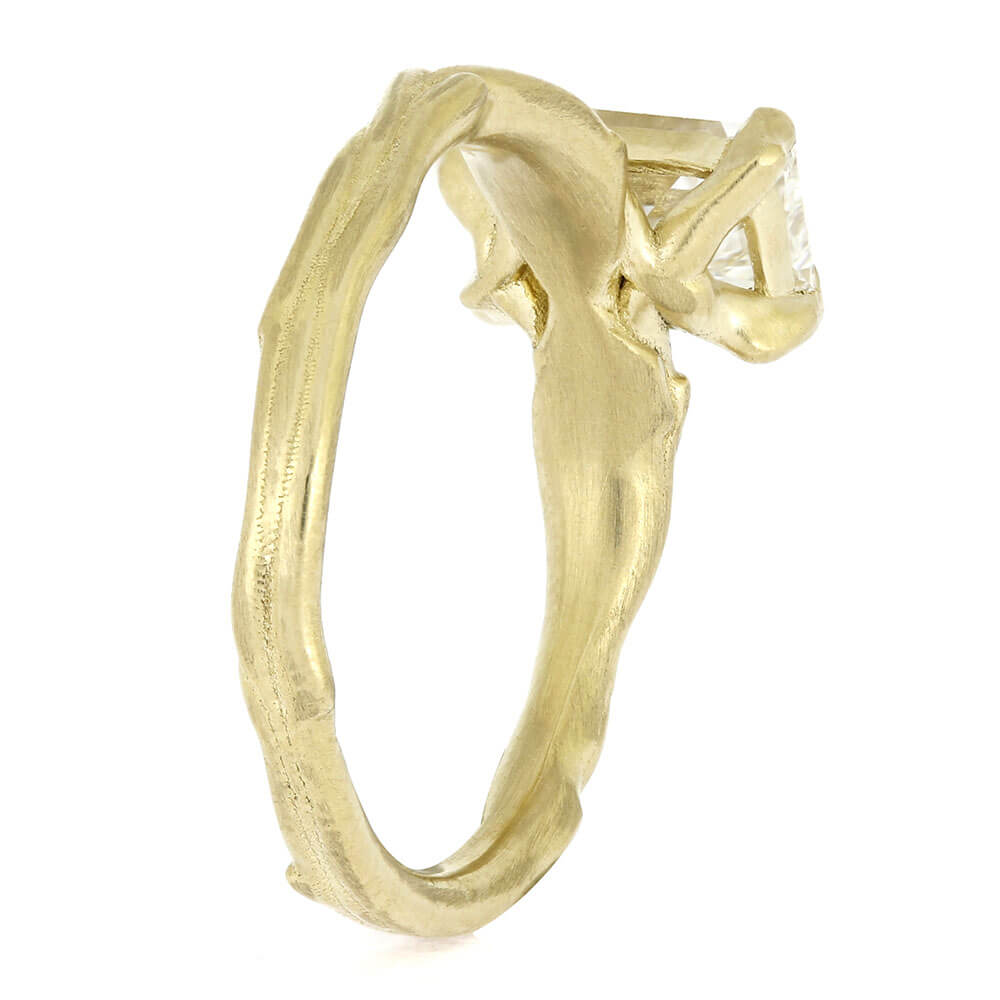 Gold ring with a diamond on a white background