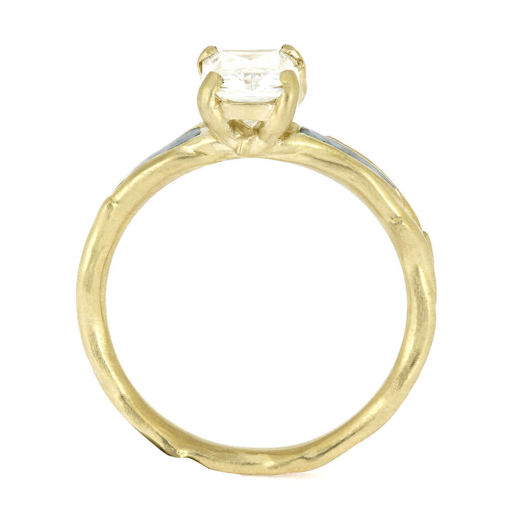 Gold ring with a diamond on a white background