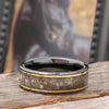 Black Ceramic Horse Hoof Ring with Gold Pinstripes on rustic wood, showcasing polished finish and unique hoof texture in jewelry category.