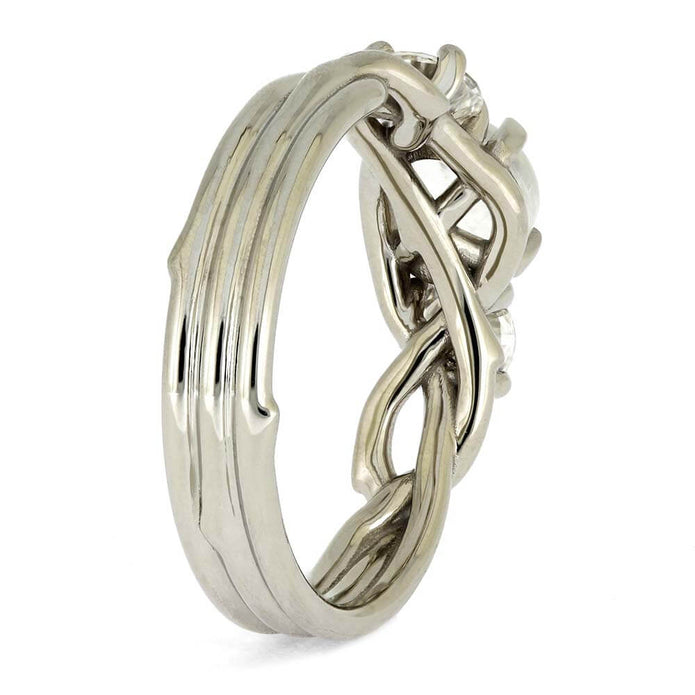 Silver ring with intricate design on a white background
