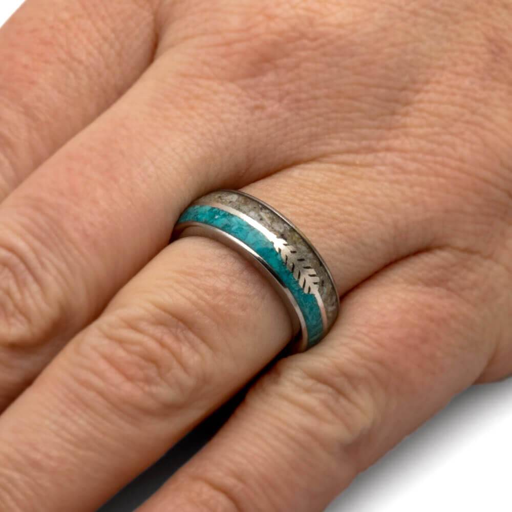Ring with silver arrow and turquoise on finger