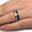 Meteorite mountain ring with dinosaur bone on finger