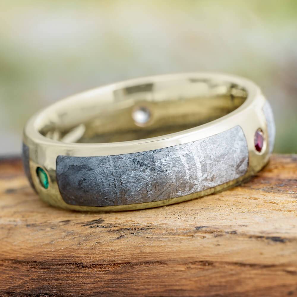 Meteorite wedding band with gemstones on wood