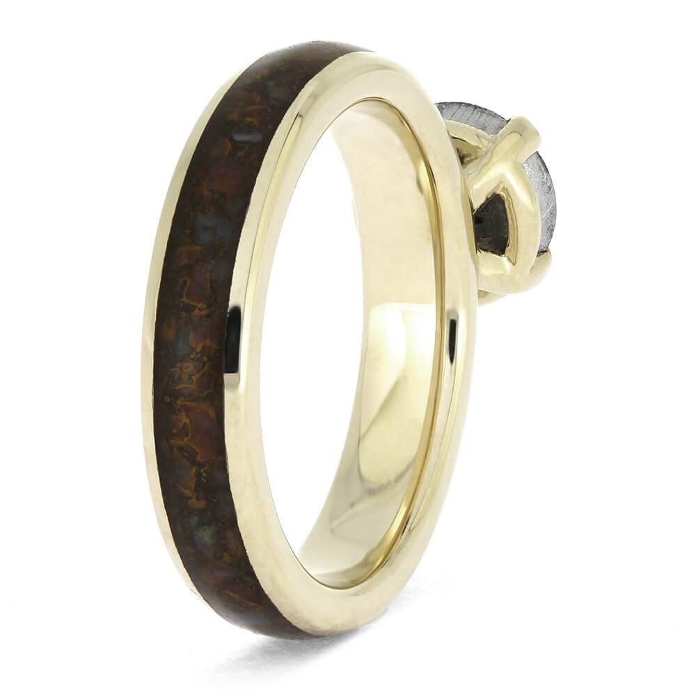 Side view of white gold ring with meteorite and dinosaur bone