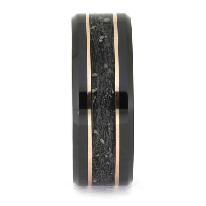 Black ring with rose gold inlay on a white background