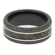 Black ring with gold band on a white background