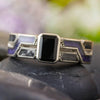 Black engagement ring with onyx and amethyst, front view