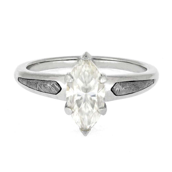 Silver ring with a marquise-shaped diamond on a white background