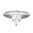 Silver ring with a marquise-shaped diamond on a white background