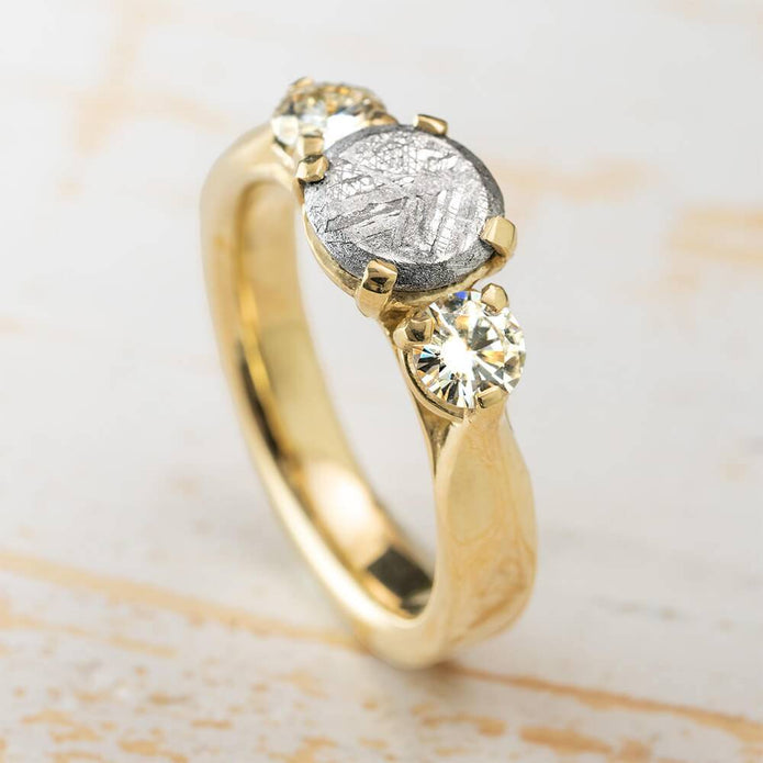 Classic three stone meteorite engagement ring in yellow gold