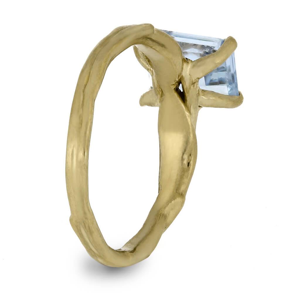 Side view of aquamarine ring with vine-like band