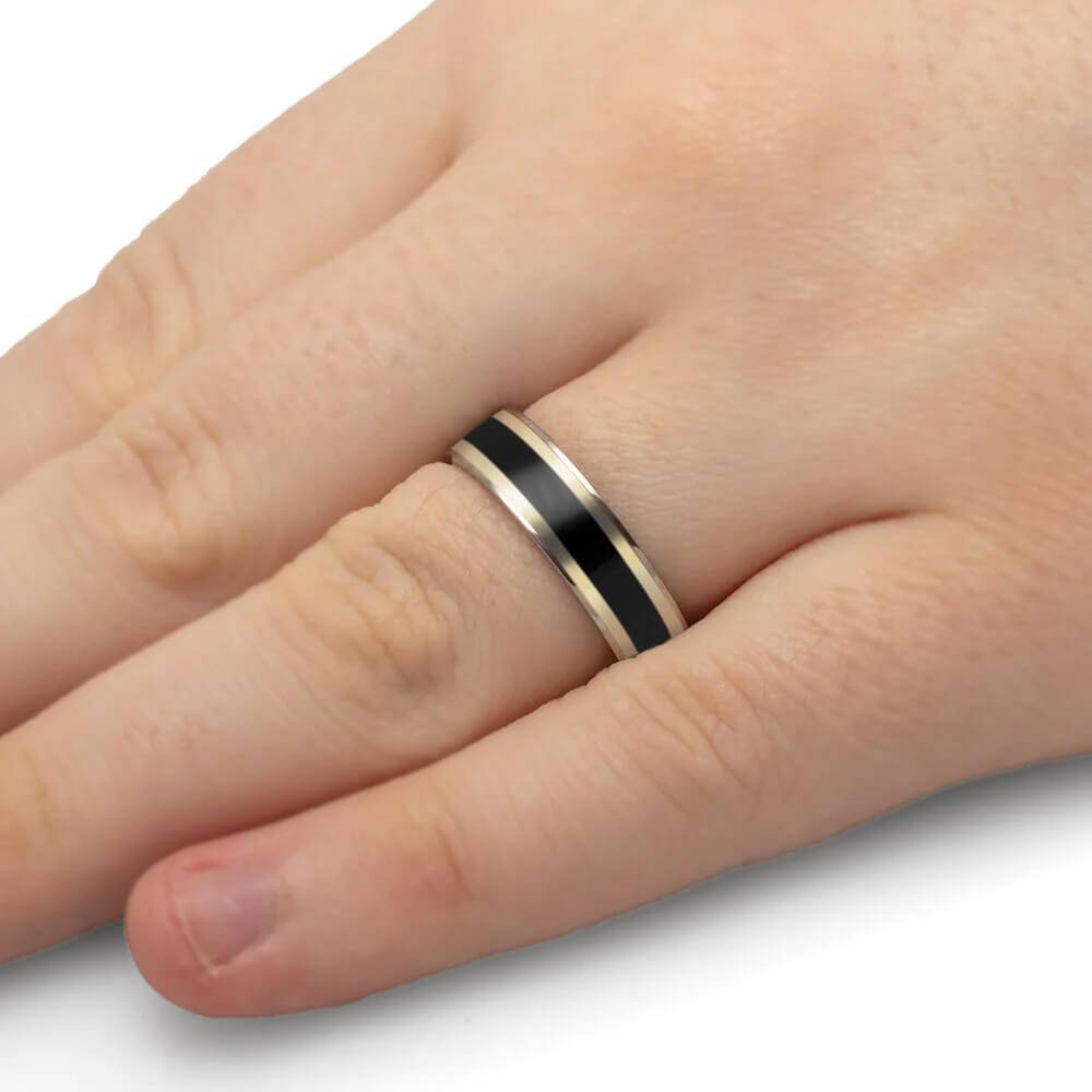 Blackwood ring with white gold pinstripes worn on hand