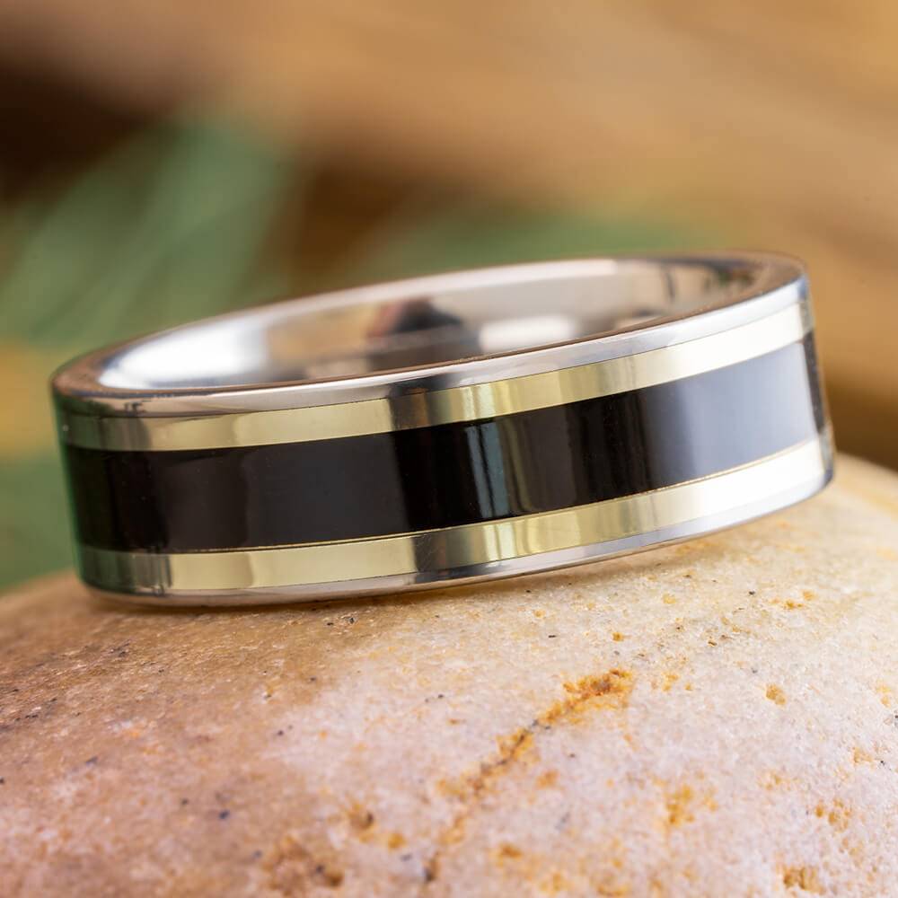 Titanium ring with blackwood and white gold pinstripes on stone