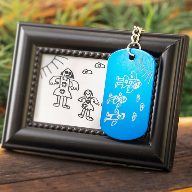 Custom engraved blue dog tag keychain with framed drawing