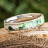 Moss agate wedding band in titanium on wood