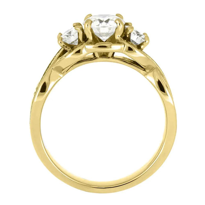 Profile view of three stone yellow gold ring with prong setting