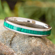 Narrow green malachite wedding band on rock