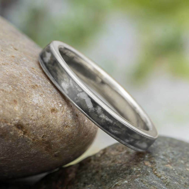 Titanium golf tee wedding band on stone