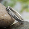 Titanium golf tee wedding band on stone