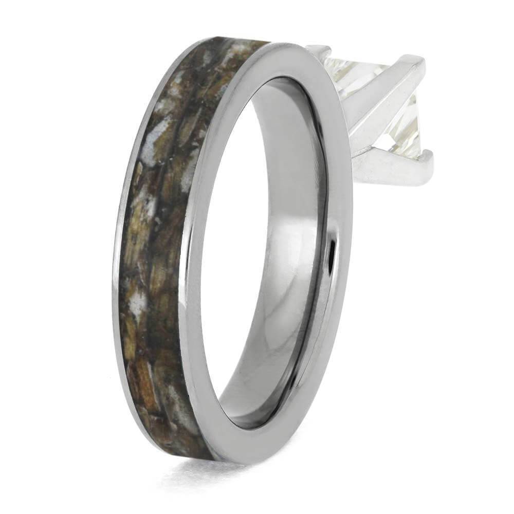 Side view of diamond ring with tee inlay