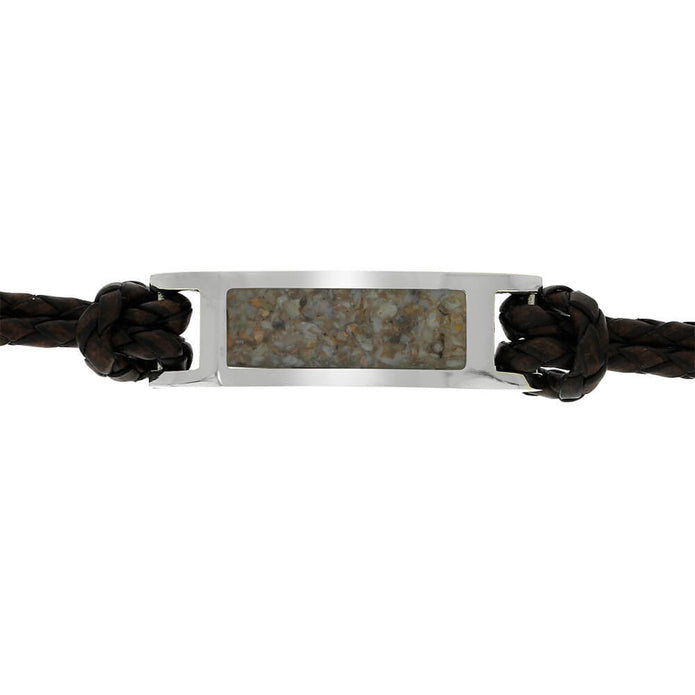 Bracelet with leather strap and metallic tag on a white background