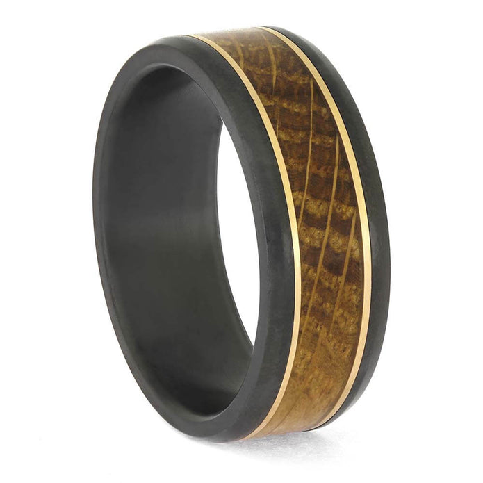 Men's gold and black zirconium wedding ring with a single whiskey oak wood inlay and gold accents, shown at an angled front view.