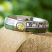 Colorful birthstone wedding band with crushed peridot and pearl inlays, featuring a bezel-set peridot on a titanium ring with polished finish.