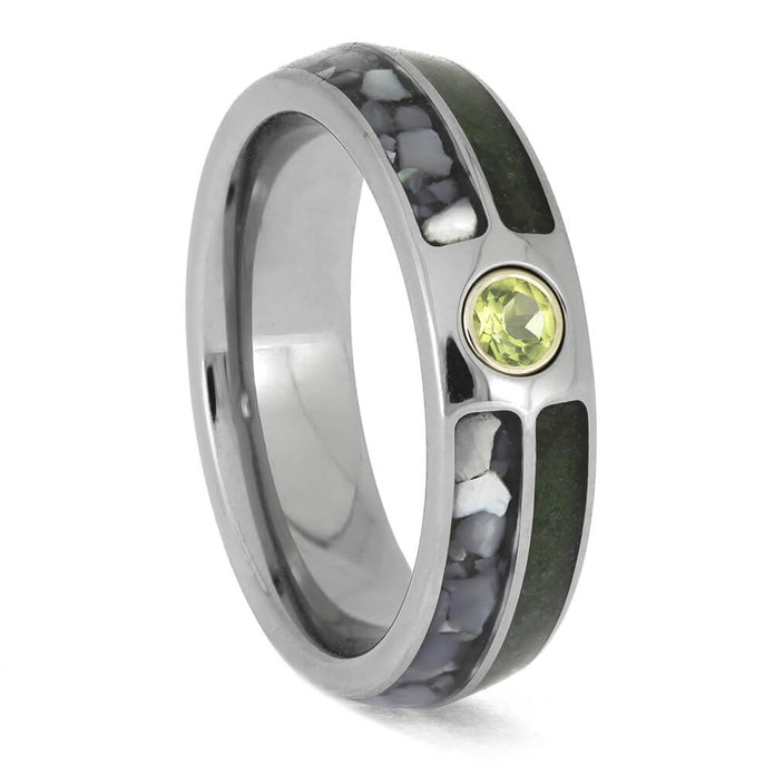 Men's titanium wedding ring with green crushed peridot, white mother-of-pearl inlays, and a round bezel-set peridot centerpiece.