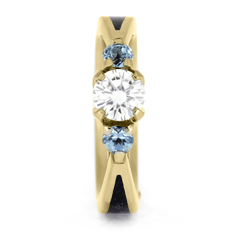 Front view of Topaz and Moissanite Engagement Ring showcasing round-cut moissanite center and two blue topaz stones in gold setting.